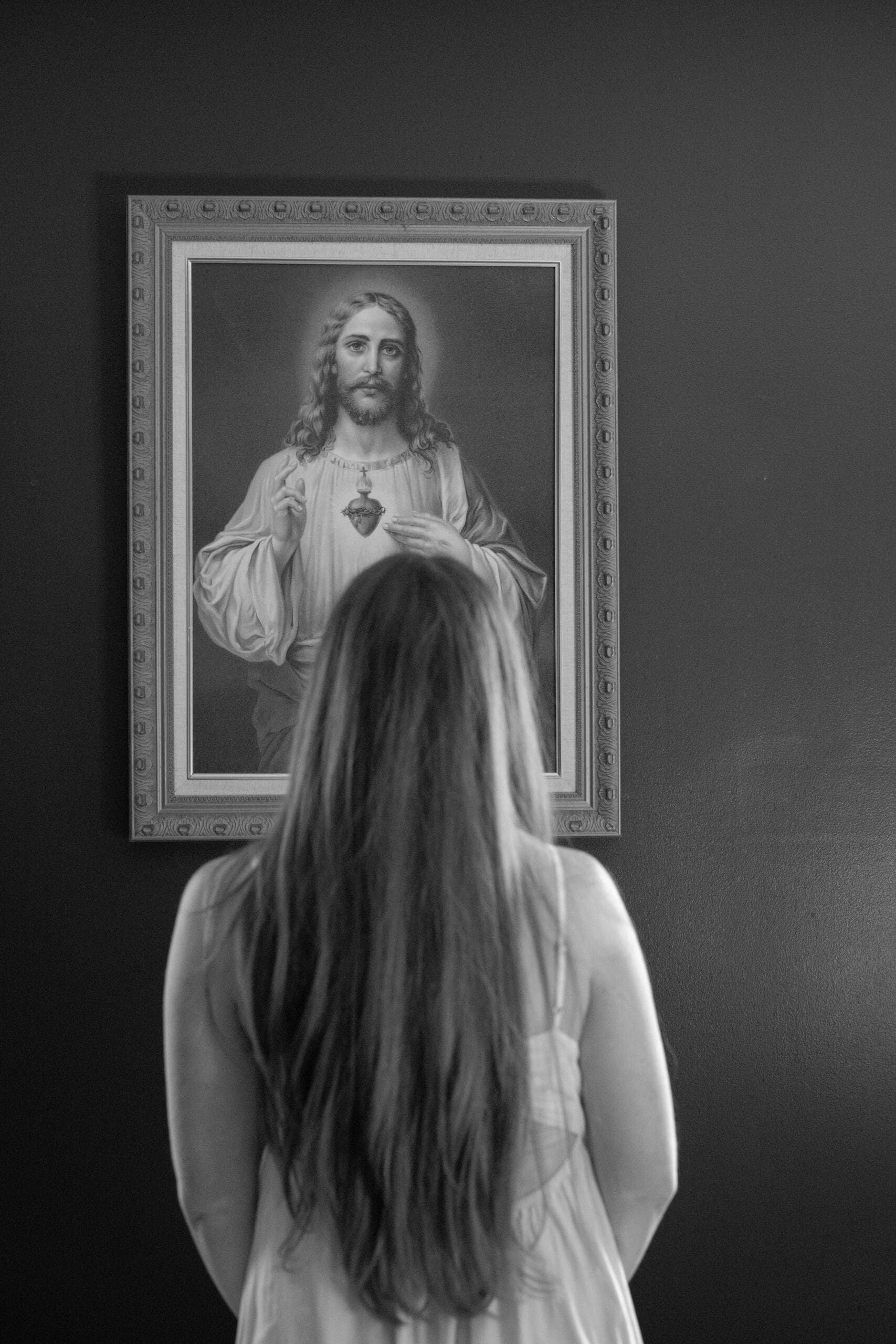 melissa standing in front of the Sacred Heart of Jesus image