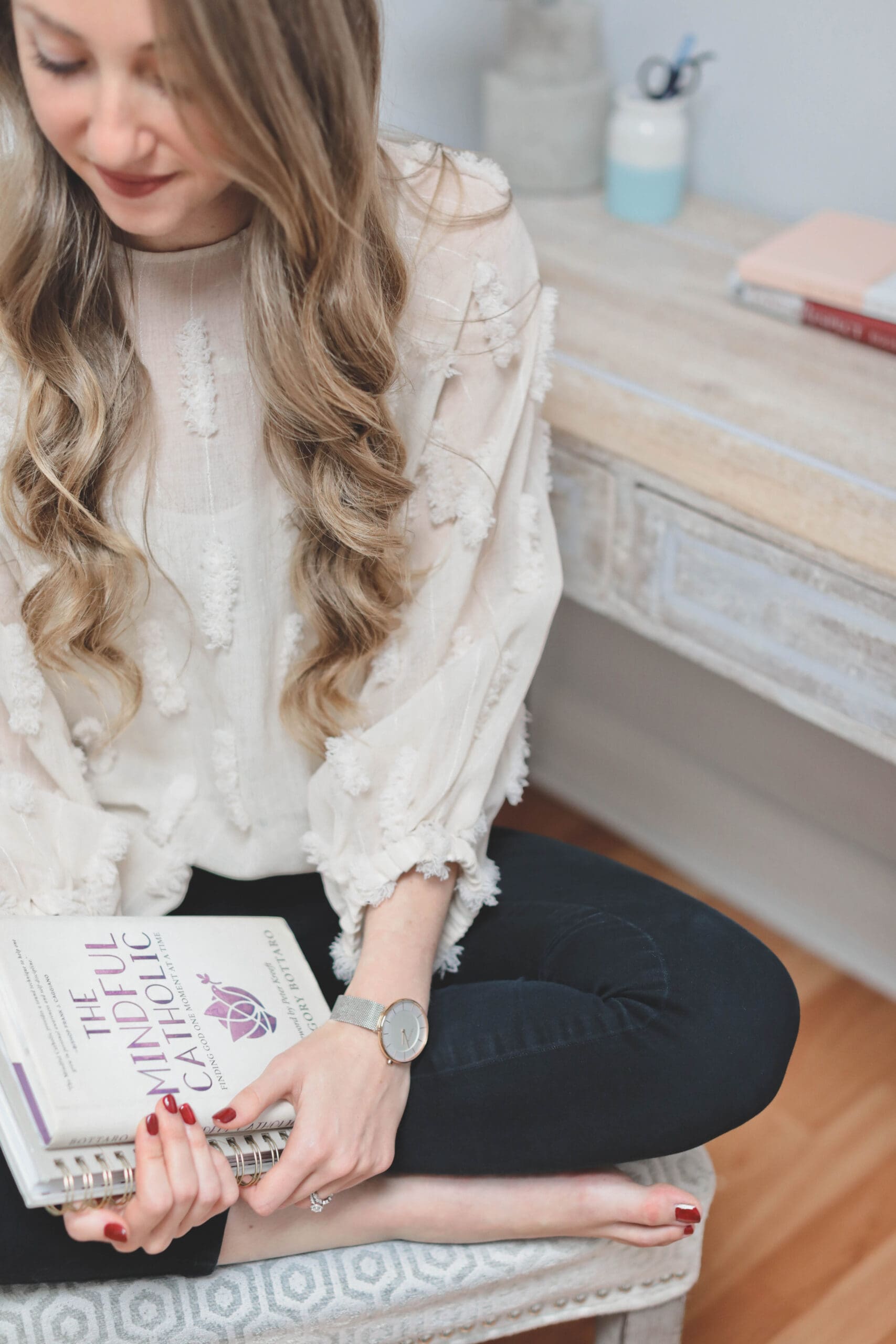 Melissa holding stack of books about the power of mindfulness