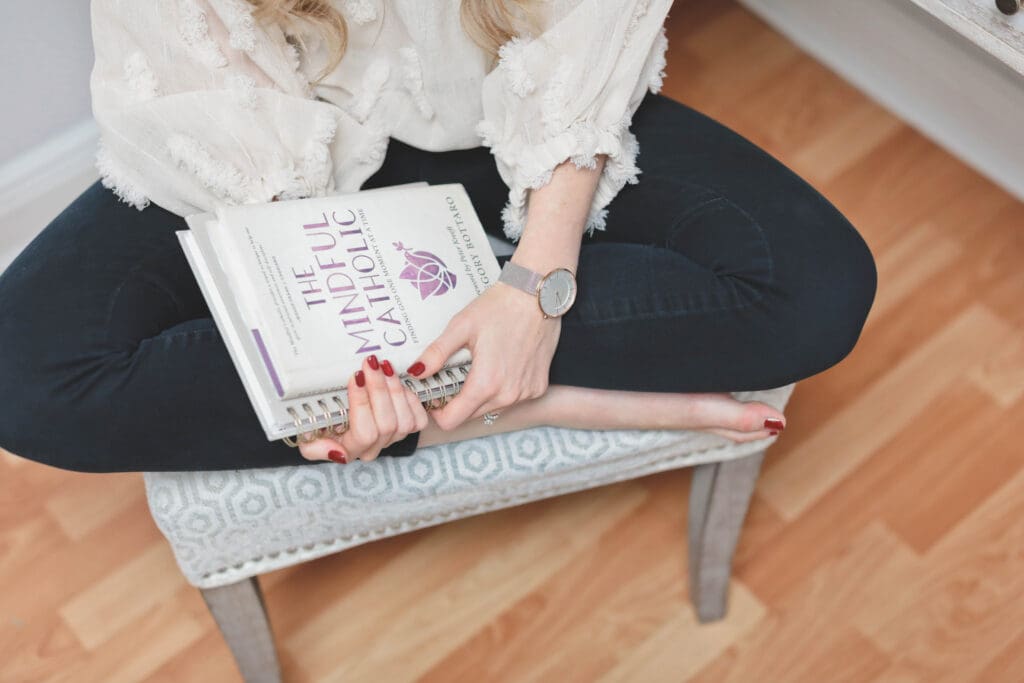 Melissa holding stack of mindfulness books
