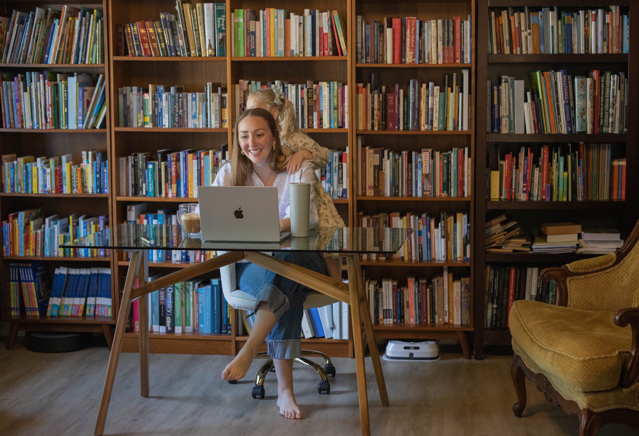 a working mom with little girl nearby learning how to avoid burn out and achieve work life balance